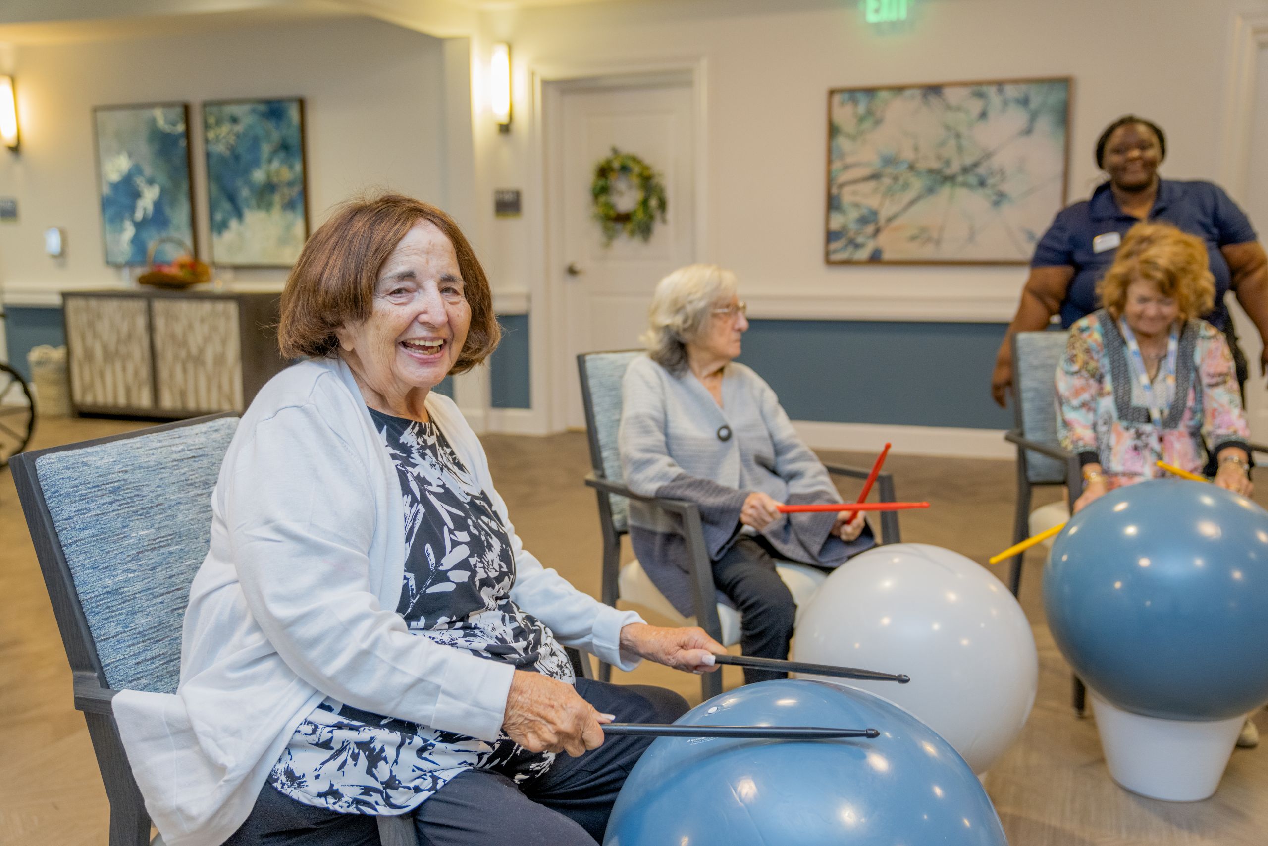 Residents of Alamar Senior Living participating in a fun and active seated fitness class