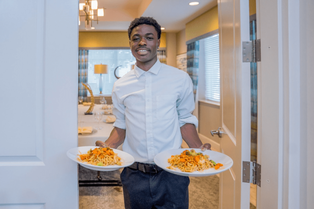 Team member providing nutritional meals to residents